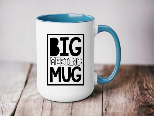 A blue and white coffee mug sitting on top of a table.