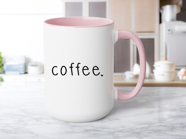 A pink coffee mug sitting on top of a counter.