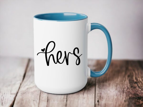 A coffee mug that says hers on it.