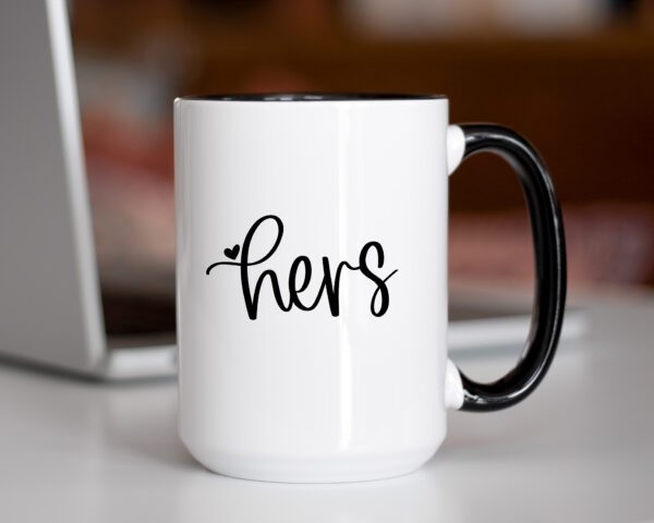 A coffee mug that says hers on it.