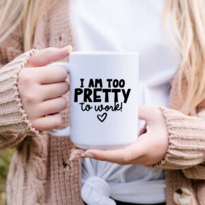 A person holding a coffee mug that says " i am too pretty to work ".