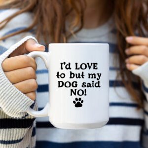 A woman holding a coffee mug that says " i 'd love to but my dog said no ".