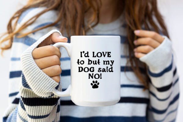 A woman holding a coffee mug that says " i 'd love to but my dog said no ".