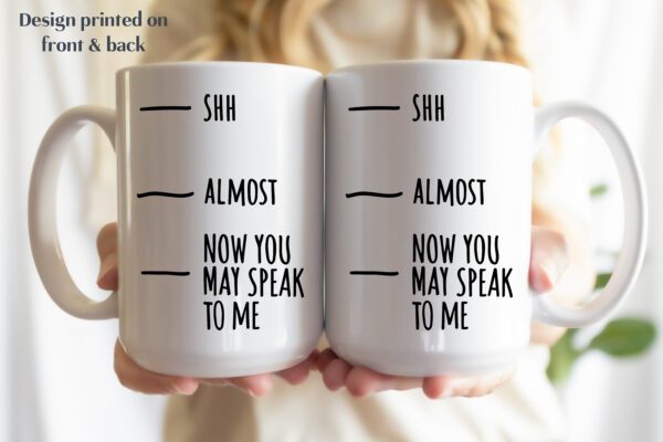 A person holding a coffee mug with the words " shh almost now you may speak to me ".