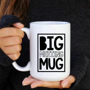 A person holding a big mug with the words " big meeting mug ".