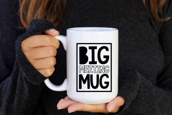 A person holding a big mug with the words " big meeting mug ".