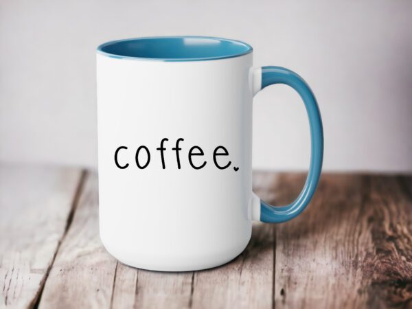 A coffee mug sitting on top of a wooden table.