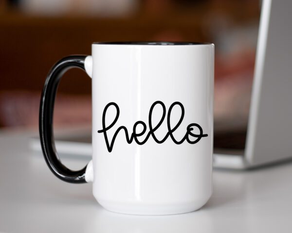 A coffee mug that says hello on it.