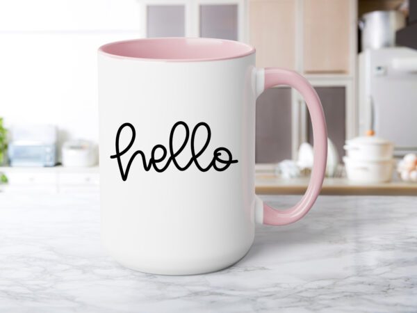 A pink coffee mug sitting on top of a counter.