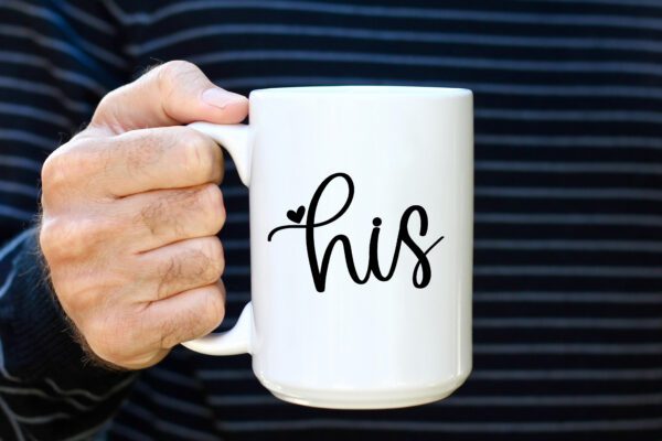 A man holding his coffee mug with the word " his " written on it.