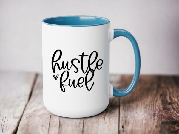 A coffee mug that says hustle fuel on the side.