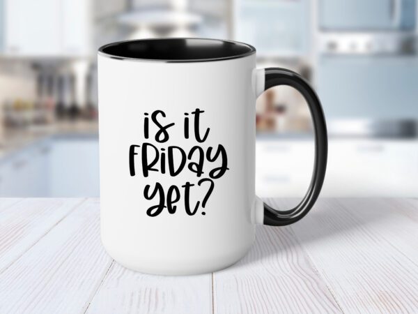 A coffee mug that says is it friday yet