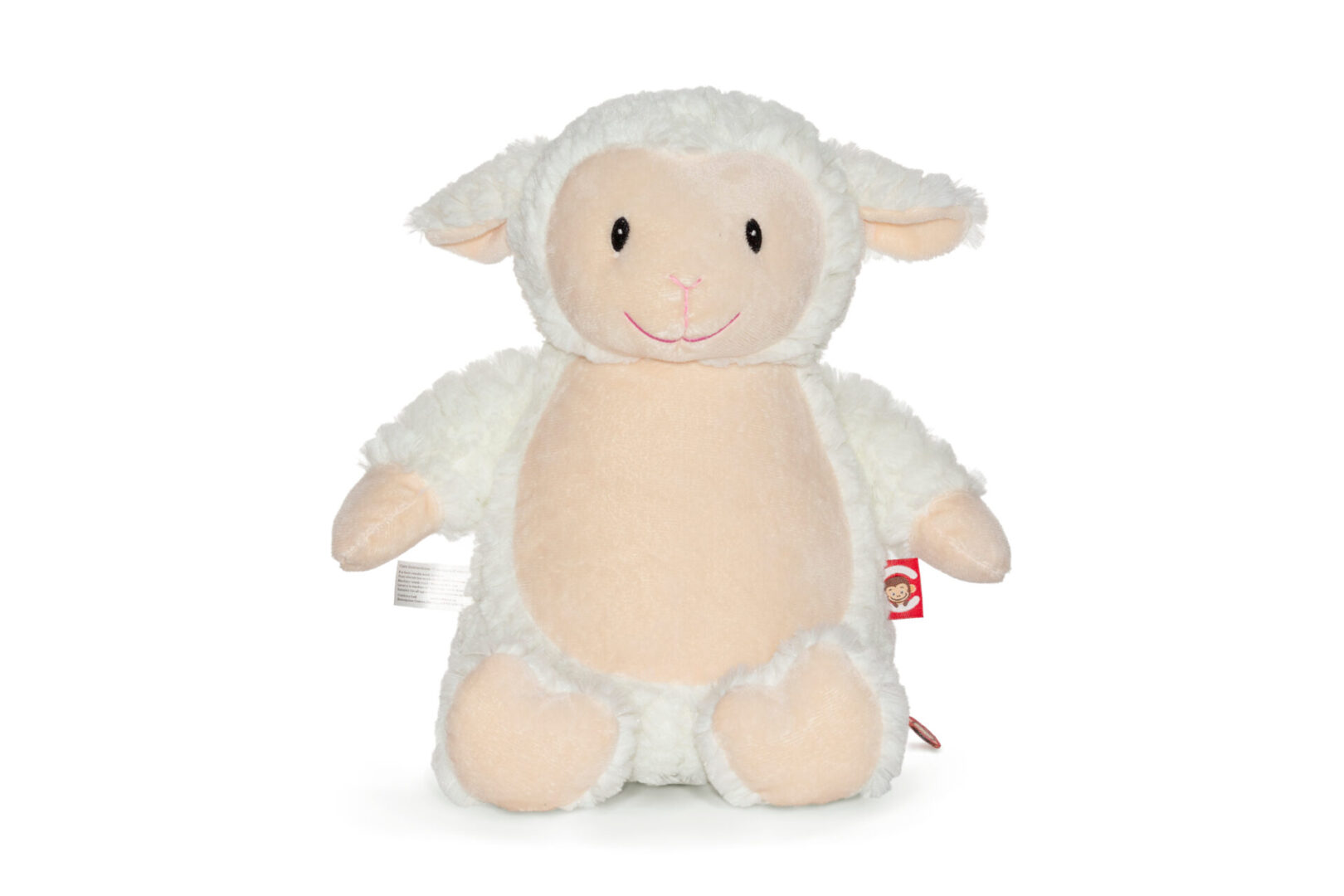 A stuffed animal lamb is sitting on the floor.