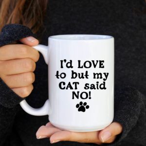 A person holding a coffee mug that says " i 'd love to but my cat said no ".