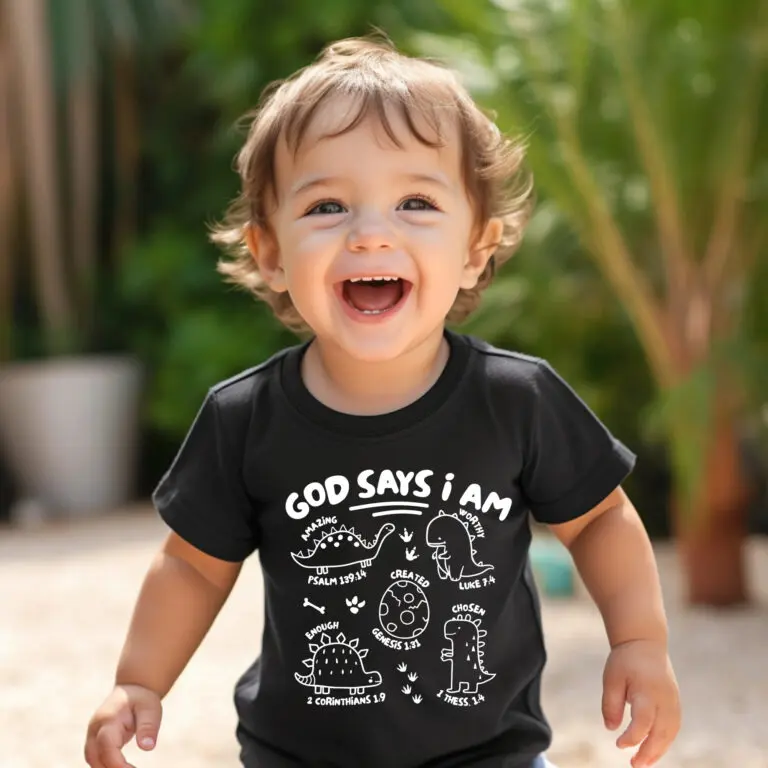 A toddler is laughing and wearing a black shirt.