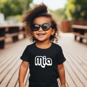 A little girl wearing sunglasses and a black shirt