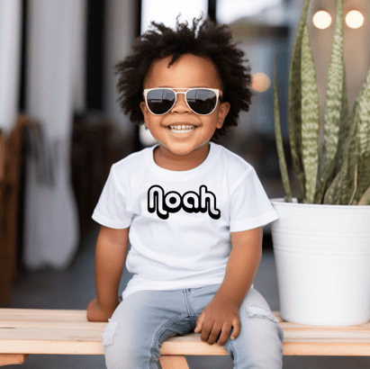 A little boy sitting on top of a bench.