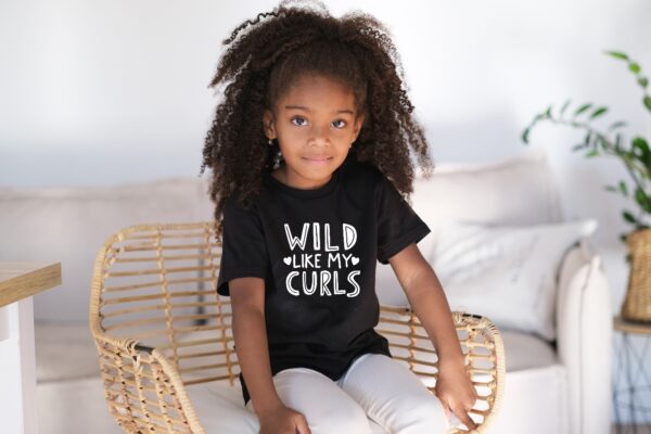 A little girl sitting on top of a chair.