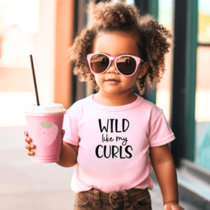 A little girl holding a cup of coffee