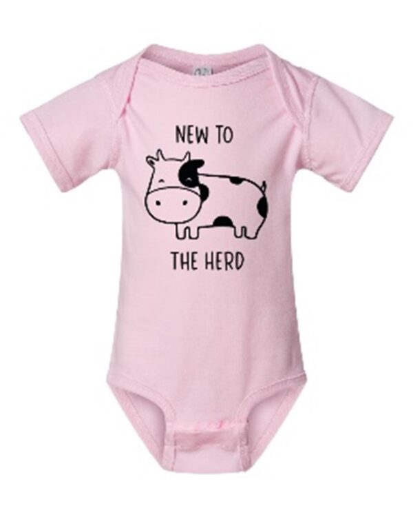 A pink onesie with an image of a cow.